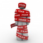 a person wrapped in red tape that says fear