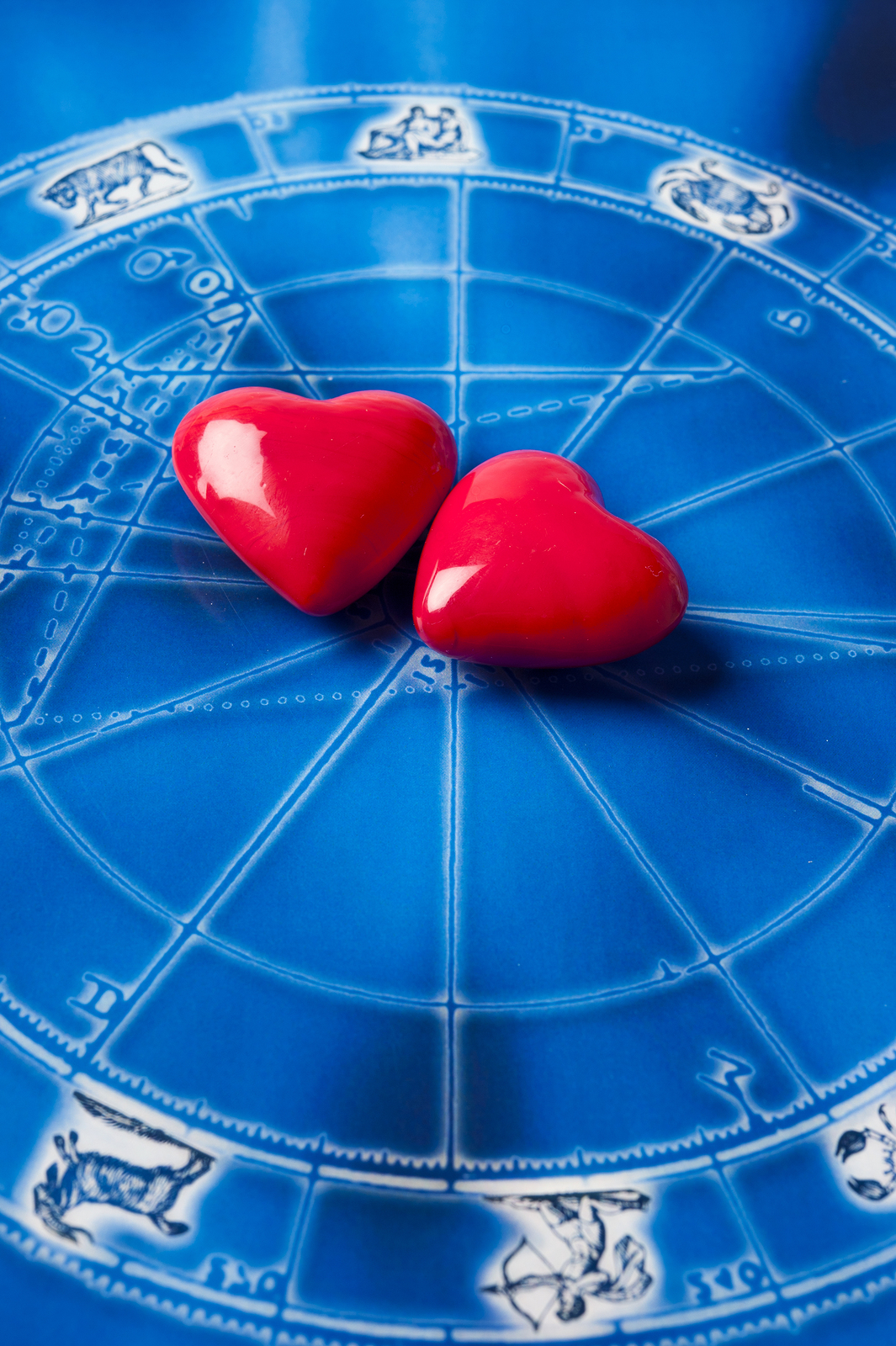 two red hearts over blue astrology map