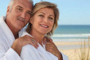 Elderly couple wearing white at the beach