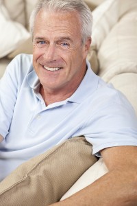 Happy and healthy senior man at home smiling