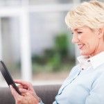 woman over 50 using tablet computer