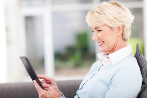 woman over 50 using tablet computer