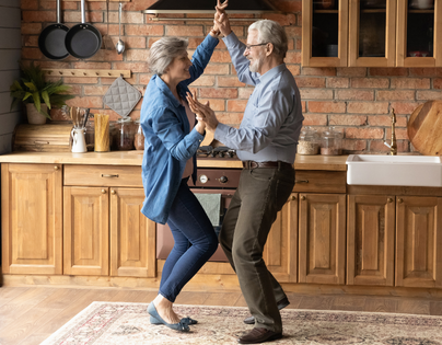mature couple dancing in the kitchen